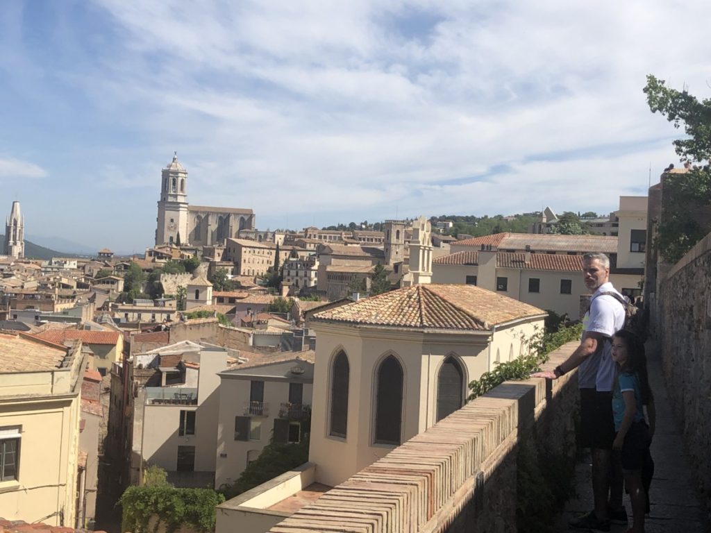 Dad and daughter on wall of Girona overlooking the city and the cathedral in the background