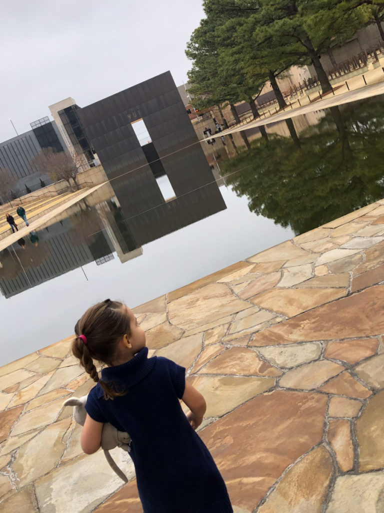 Toddler looks over the reflection pool at the Oklahoma National Memorial Plaza