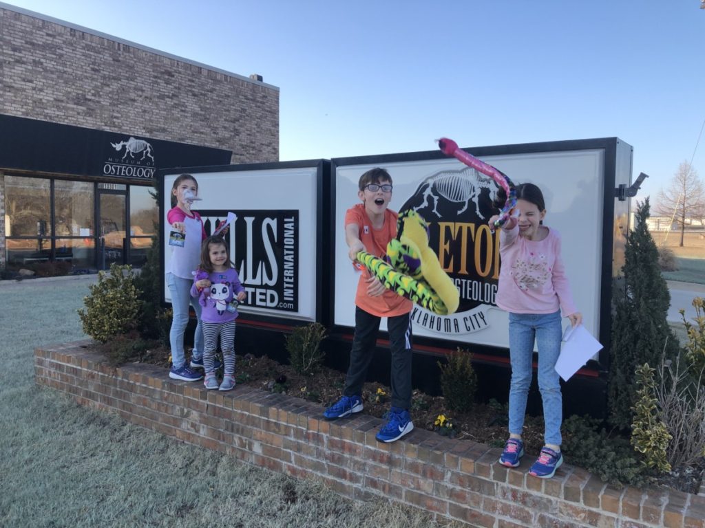 4 kids with stuffed animals from the Osteology Skeleton museum in OKC 