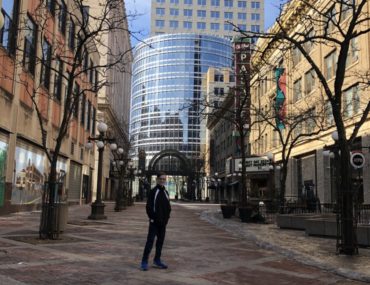 boy stands in a brick walkway in St. Paul near the Minnesota Children's Museum