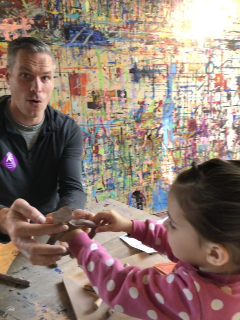 Dad creates a diamond bracelet for toddler at the Art Space in Minnesota Children's Museum