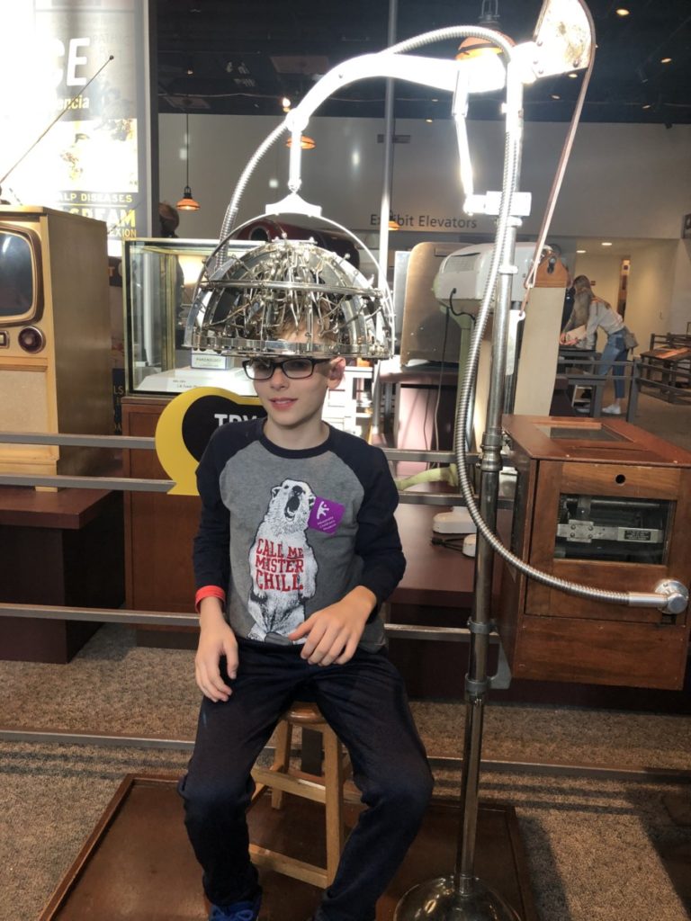A boy with a electricity helmet at the Minnesota Science Museum