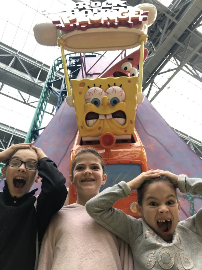 3 kids look squared at Spongebob Squarepants Rock Bottom Rollarcoaster at Nickelodeon Universe 