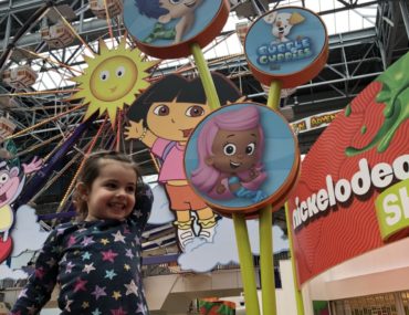 Toddler showing rides El Circulo de Cielo and Guppy Bubbler at Nickelodeon Universe in Mall of America in Minneapolis