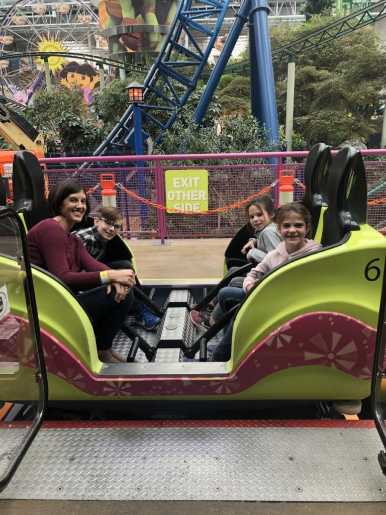 Mom and 3 kids in the fairy odd Coaster spinning car at Nickelodeon Universe in the Mall of America Minneapolis