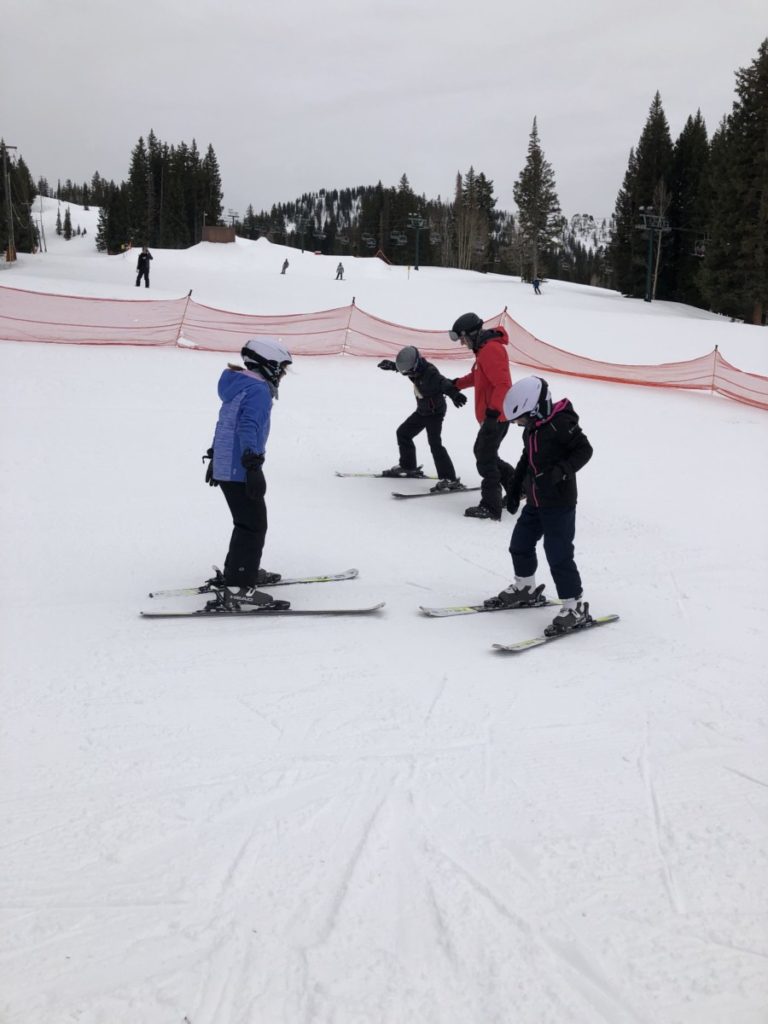3 kids at ski school at Brighton Ski resort in Utah