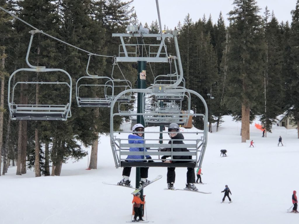 2 kids on the ski lift at Brighton Ski Resort