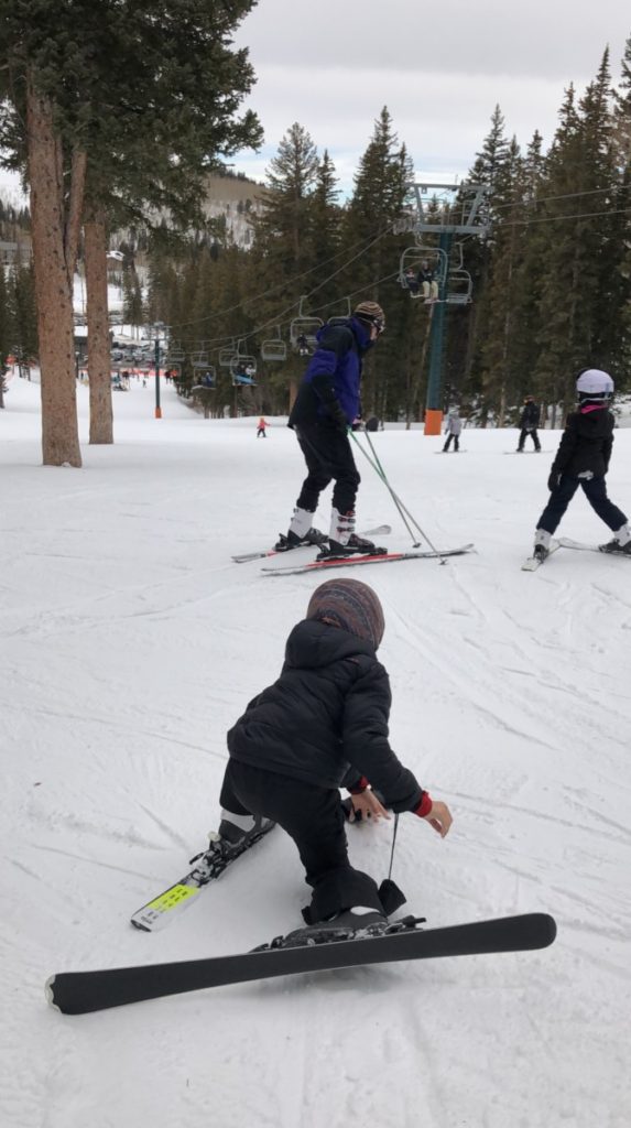 Boy gets up while skiing at Brighton Ski resort