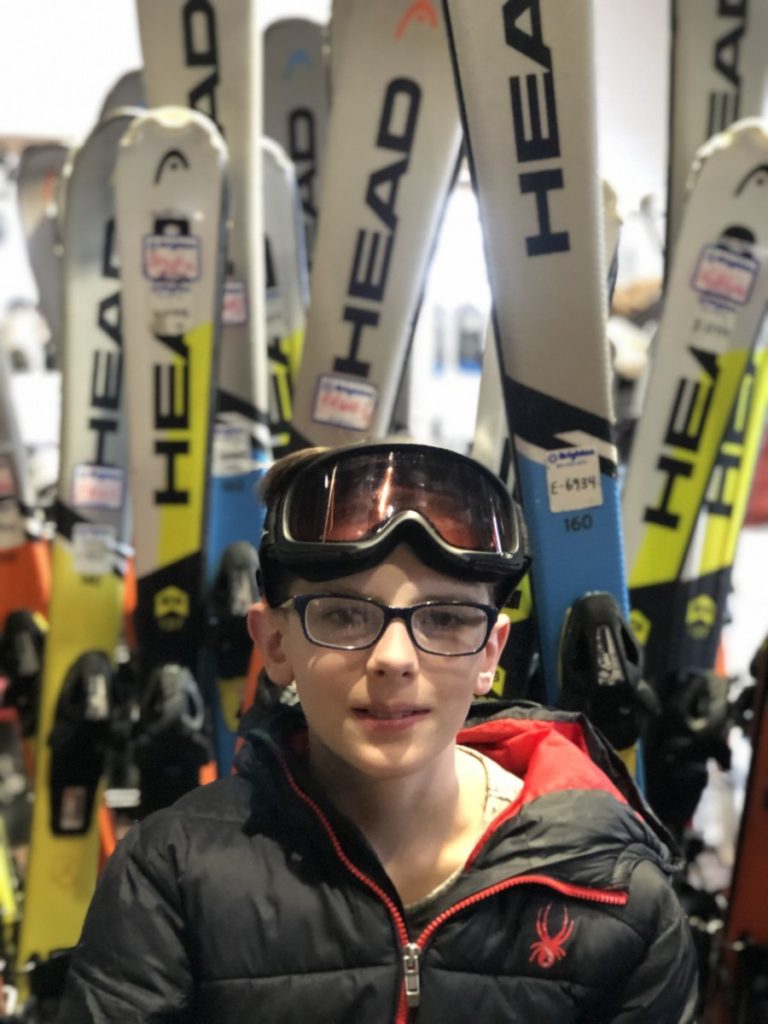 Boy in front of the ski rentals at Brighton Ski Resort