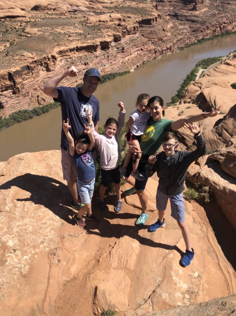 Family of 6 looking over the colorado river on a Moab adventure Center Hummer Safari tour