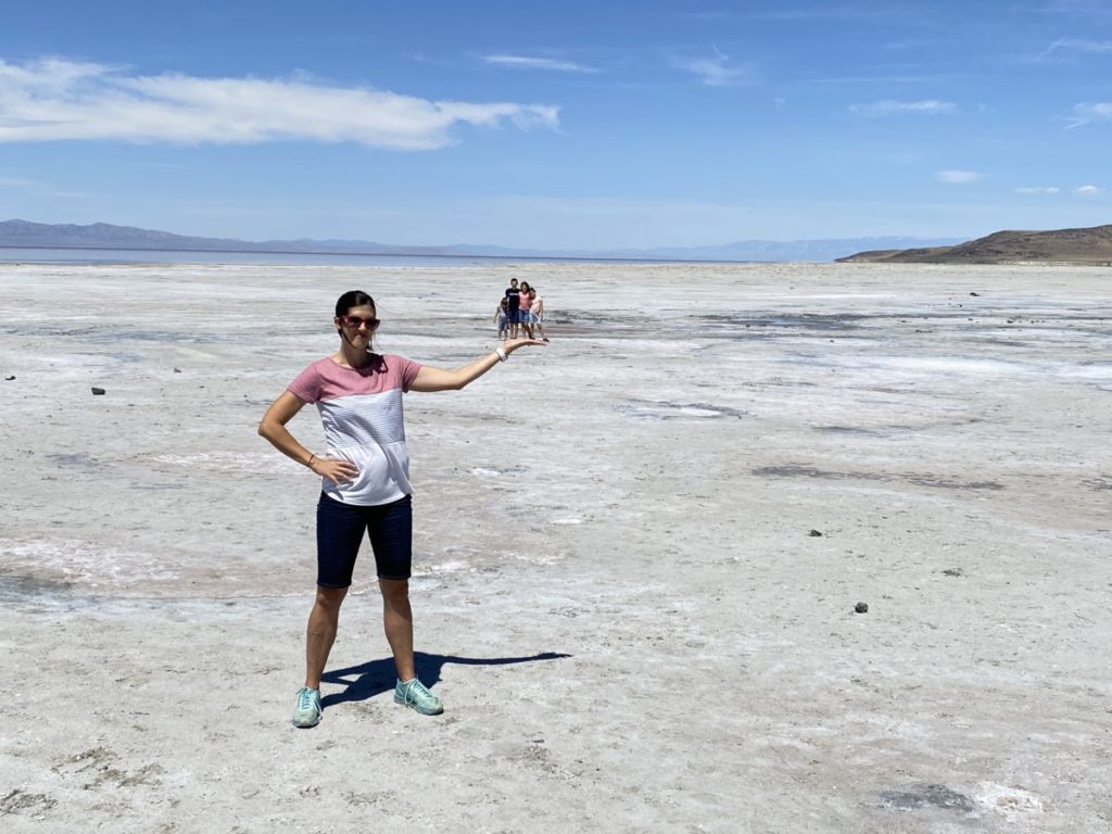 Mom holding four kids in her hand at the Great Salt Lake Salt Flats near Spiral Jetty