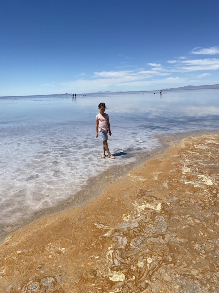 a young girl standing in the Great Salt Lake yellow shoreline