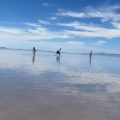 Dad and 2 daughters skipping rocks in the Great Salt Lake