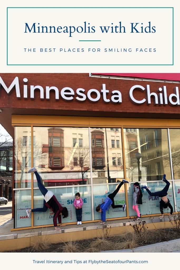 Mom and 4 kids doing handstand in front of the Minnesota Children's museum Pin for Minneapolis with kids blog post