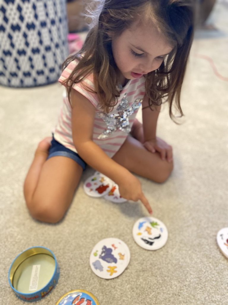 Young Girl pointing to Spot it Junior animal cards