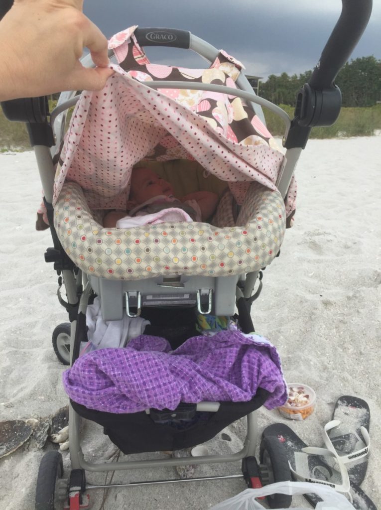 Baby in Carseat and snap and go stroller on the Beach in Fort Myers