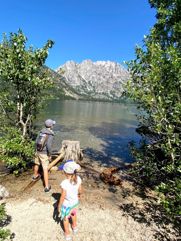 boy and girl looking over Jenny lake to the Tetons hiking in Grand Teton National Park