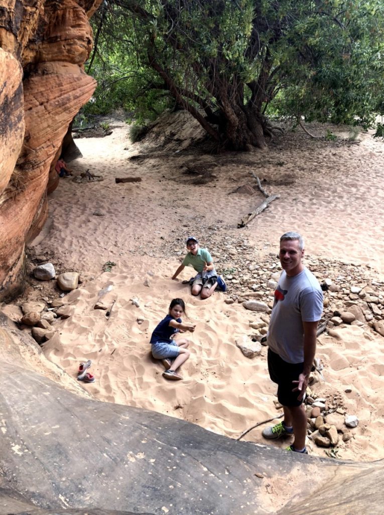 Sandy Area with a large tree and 2 kids playing while hiking in East Zion National Park