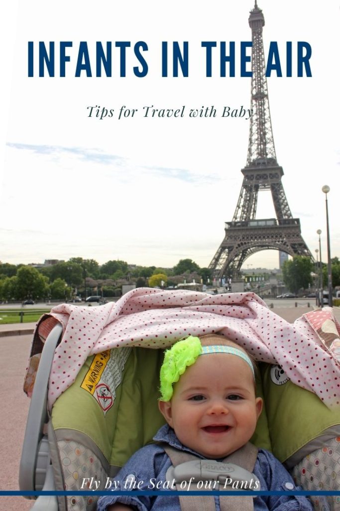 Baby in Carseat in front of the Eiffel Tower