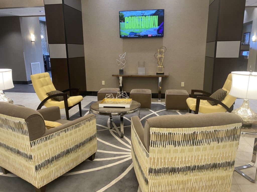 Decorative Chairs and lobby in TV viewing area inDrury Inn and Suites Frisco