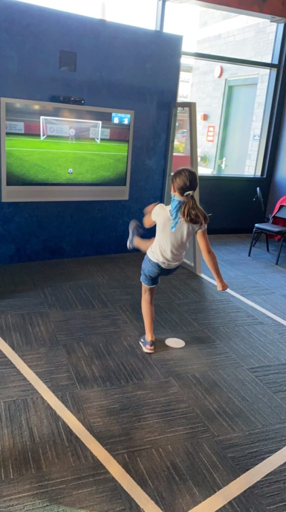 A girl kicks a virtual soccer goal at the National Soccer Hall of Fame