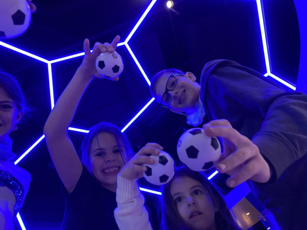 Kids show the soccer balls at the National Soccer Hall of fame