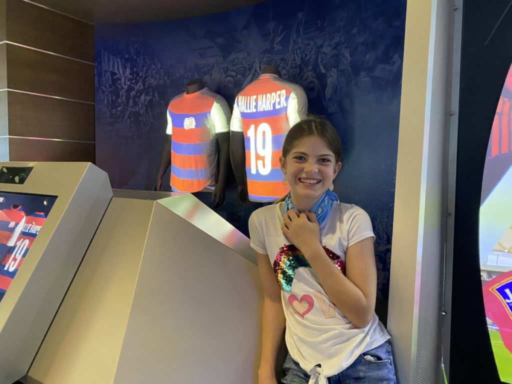 A girl creates a soccer jersey at the National Soccer Hall of Fame