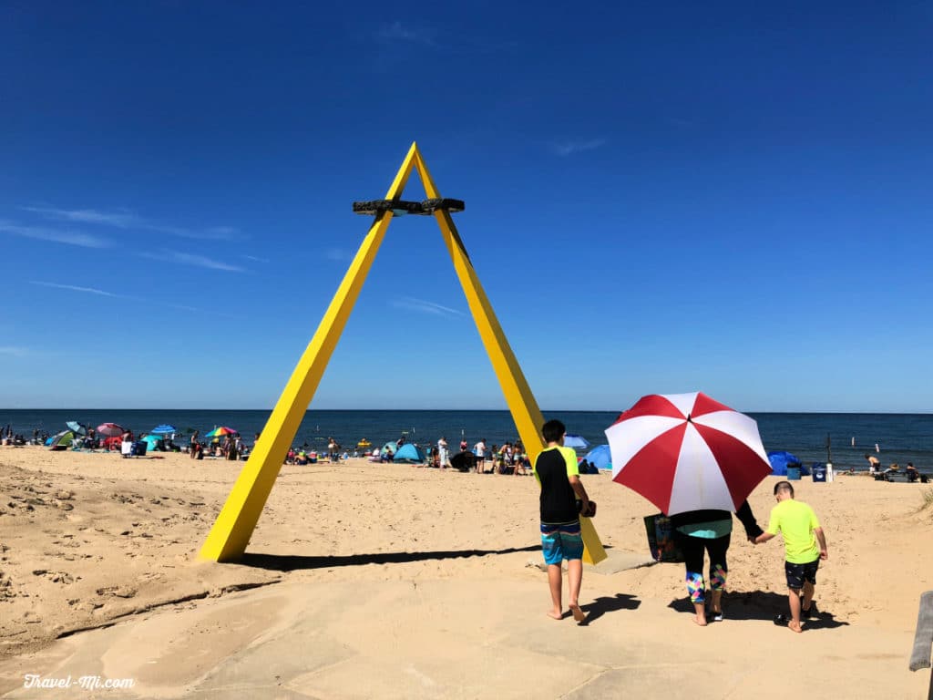  A family walks un the yellow A to Silver Beach on the Great Lakes in Michigan 