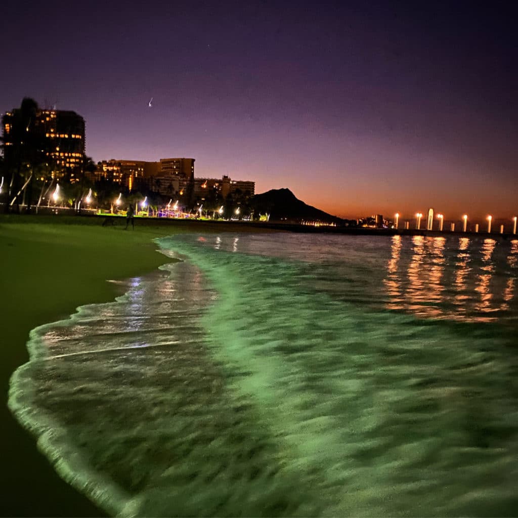 the sunrises over Diamond Head craters on Waikiki beach in Honolulu, Hawaii