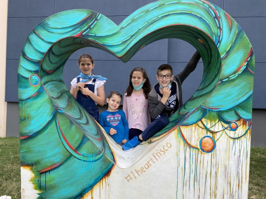 4 kids in the I heart Frisco Art installation at the Discovery Center