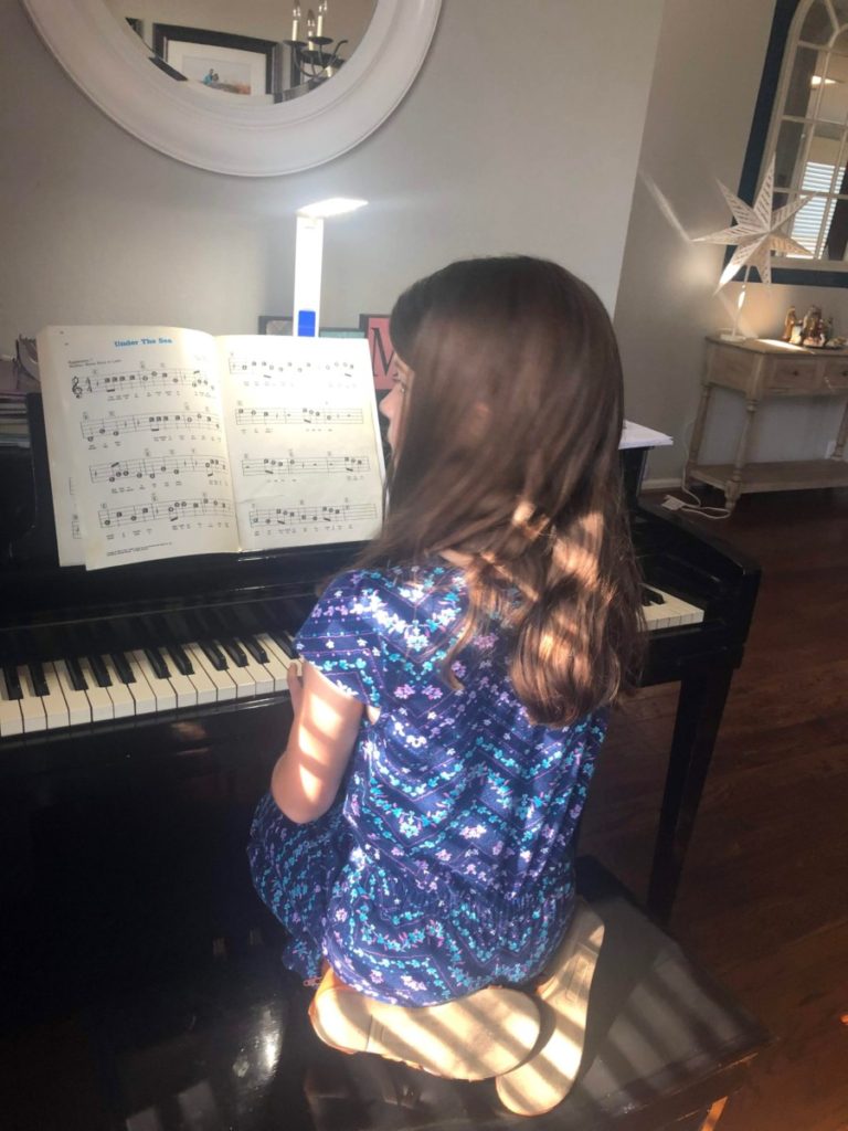 Girl plays piano at home