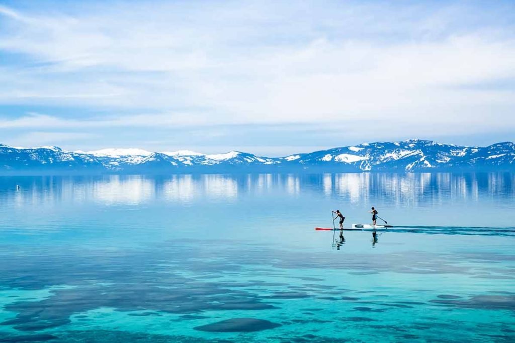 Stand up paddle boarders on a blue Lake Tahoe