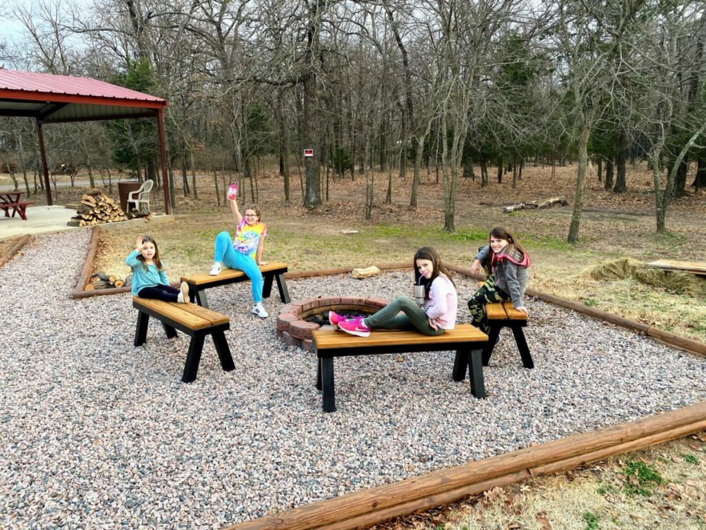 4 girsl sitting around a fire pit at Lake Texoma Rental Home called The Spot