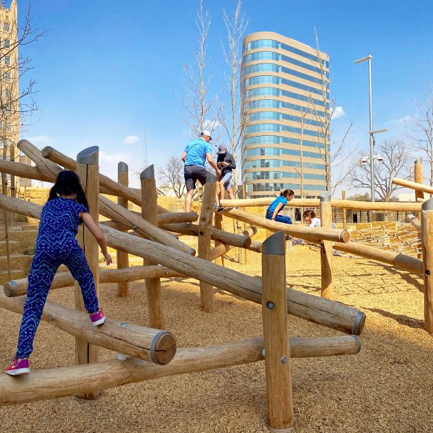 kids Climb on the log structure at Centennial Park in Midland