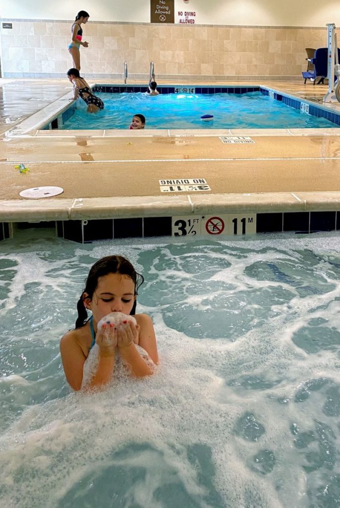 girls plays in the hot tub at Comfort Suites Spa and Pool