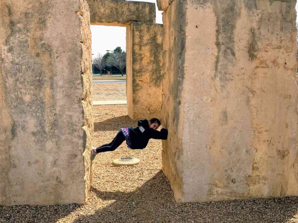 Girl climbs on the Odessa Stonehenge replica