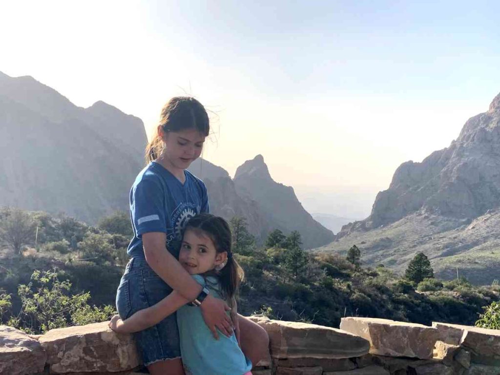 Sister hug at the Window of Chisos Mountain Basin